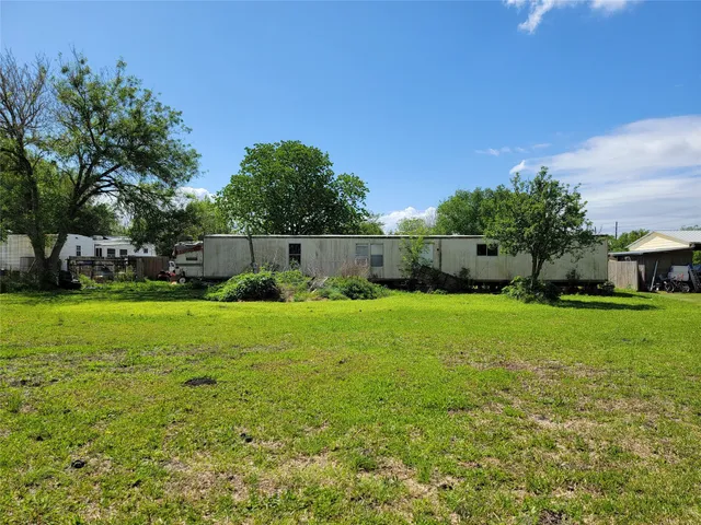 a view of yard with swimming pool and green space