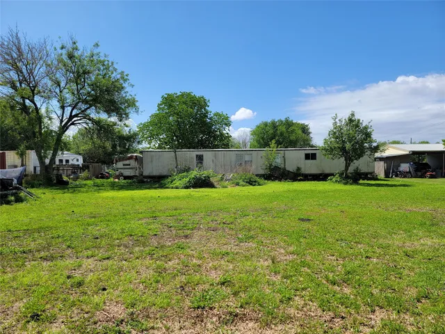 a view of yard with swimming pool and green space