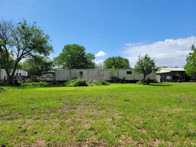 a view of yard with swimming pool and green space