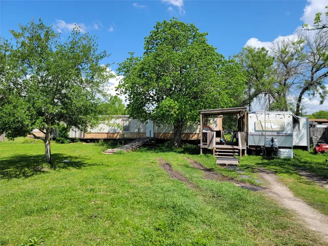 a view of a house with a yard and sitting area