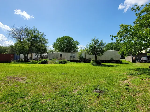 a view of house with garden space and trees
