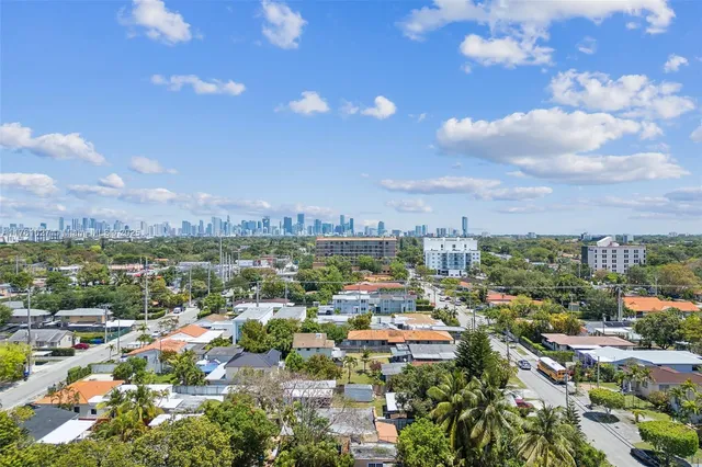 an aerial view of residential houses with city view