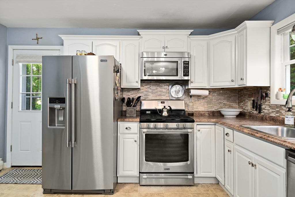 53 Mueller Road Holyoke, MA 01040 - Photo 18 of 40 a kitchen with cabinets stainless steel appliances and a sink