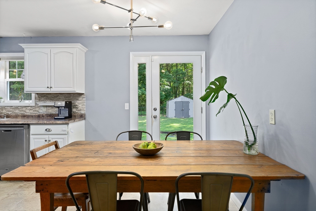 53 Mueller Road Holyoke, MA 01040 - Photo 22 of 40 a kitchen with a table chairs and white cabinets