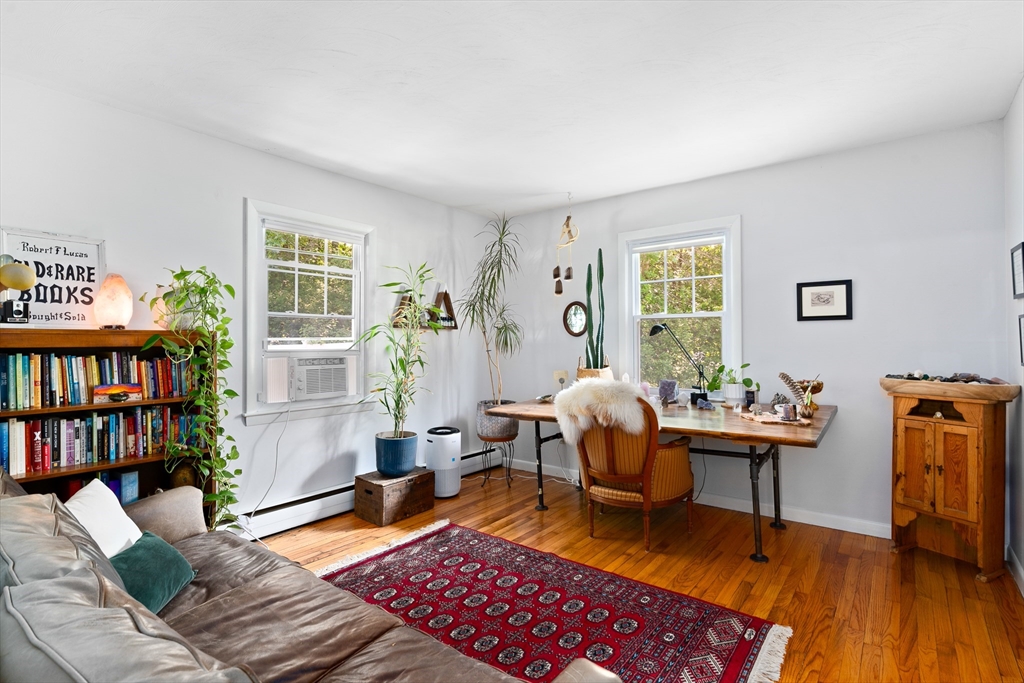 53 Mueller Road Holyoke, MA 01040 - Photo 23 of 40 a living room with furniture floor to ceiling window and wooden floor