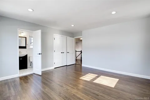 a view of empty room with wooden floor and fireplace