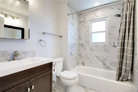 a bathroom with a sink a toilet and a bathtub