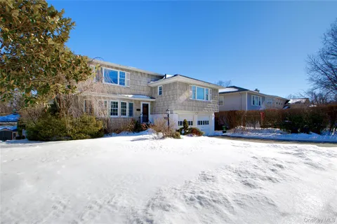 a view of a house with a yard covered in snow