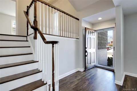 a view of entryway with wooden floor and stairs