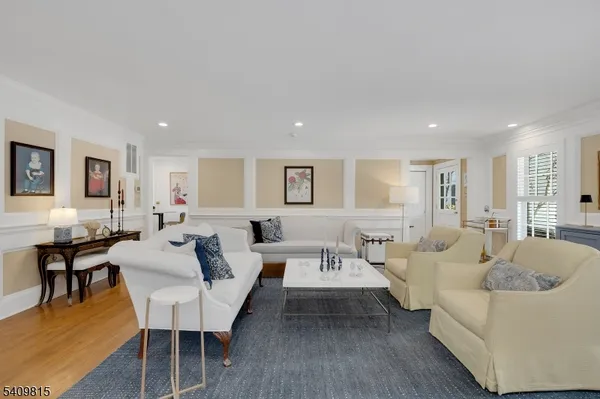 a living room with furniture wooden floor and a table