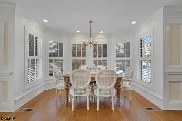 a view of a dining room with furniture windows and wooden floor