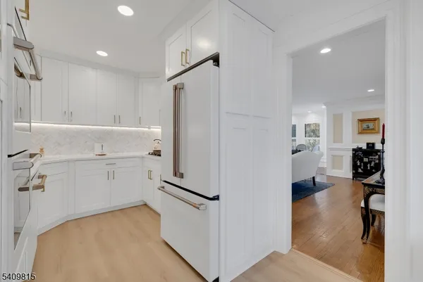 a kitchen with white cabinets a sink and dishwasher