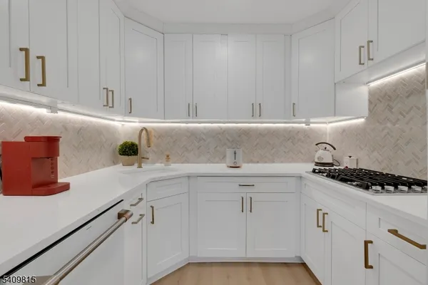 a view of kitchen with furniture and a refrigerator