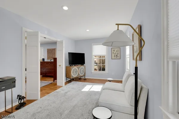 a bed room with furniture and mirror
