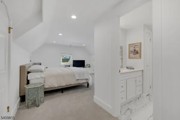 a bedroom with a bed and a chair