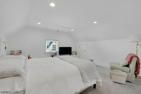a large white bed in a white room
