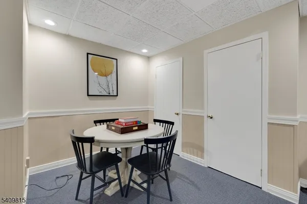 a living room with furniture a flat screen tv and a window