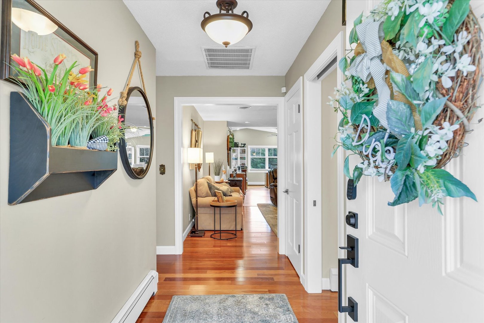 106 Cherry Drive Fithian, IL 61844 - Photo 5 of 39 a view of a hallway with wooden floor and a potted plant