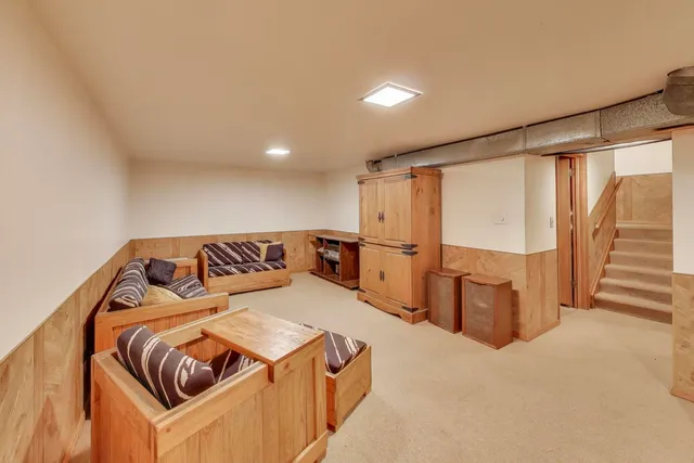 a front view of a house with garden and chairs