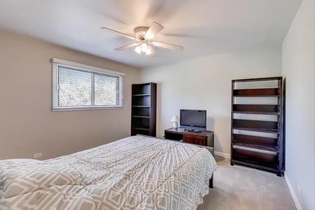a bathroom with a granite countertop sink mirror vanity and toilet