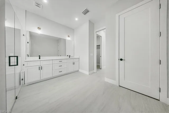 a large white cabinet with white cabinet