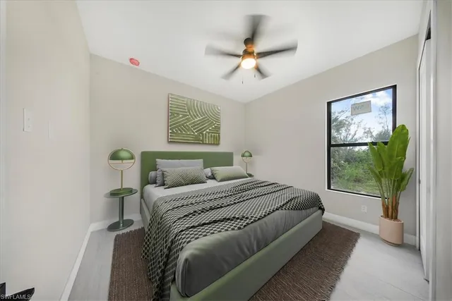 a bedroom with a bed and a painting on the wall