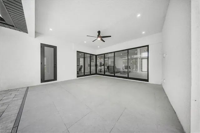 a view of an empty room with a ceiling fan