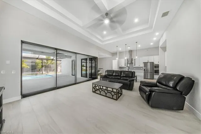 a living room with furniture ceiling fan and a rug