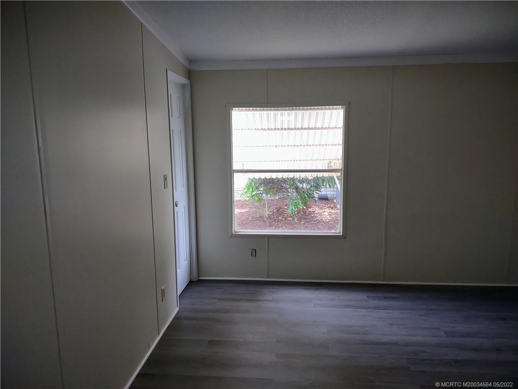 524 Thames Bluff Ridge, Unit D18 Fort Pierce, FL 34982 - Photo 16 of 24 an empty room with wooden floor and windows
