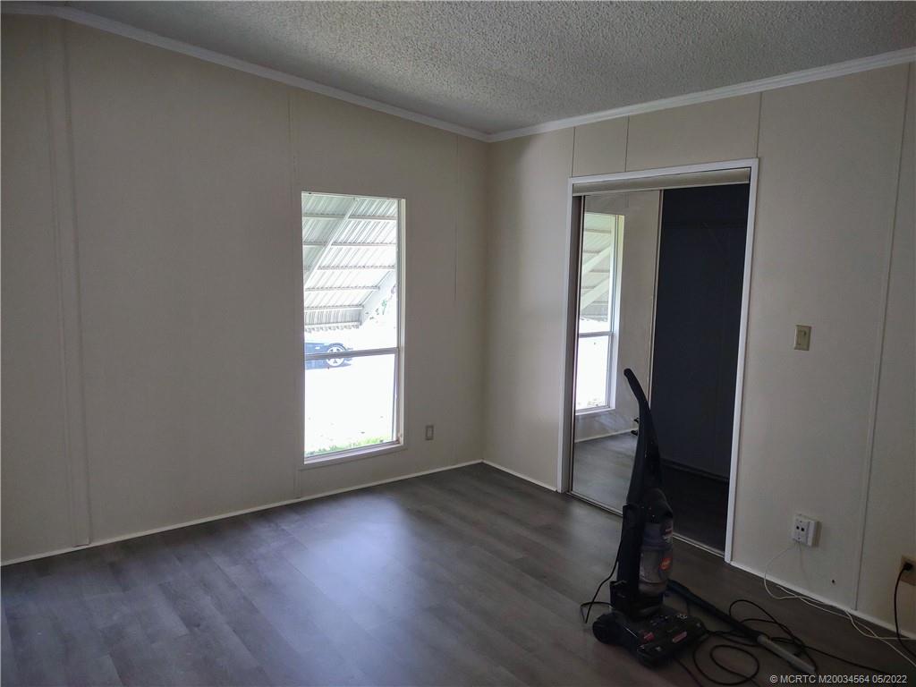 524 Thames Bluff Ridge, Unit D18 Fort Pierce, FL 34982 - Photo 19 of 24 an empty room with wooden floor and windows