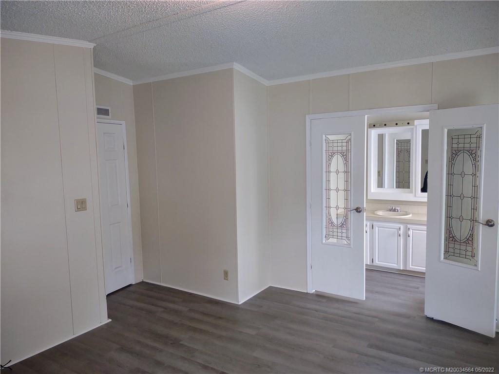 524 Thames Bluff Ridge, Unit D18 Fort Pierce, FL 34982 - Photo 20 of 24 wooden floor with white walls