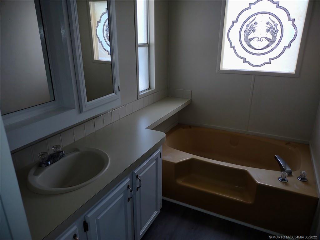 524 Thames Bluff Ridge, Unit D18 Fort Pierce, FL 34982 - Photo 23 of 24 a bathroom with a sink and a mirror
