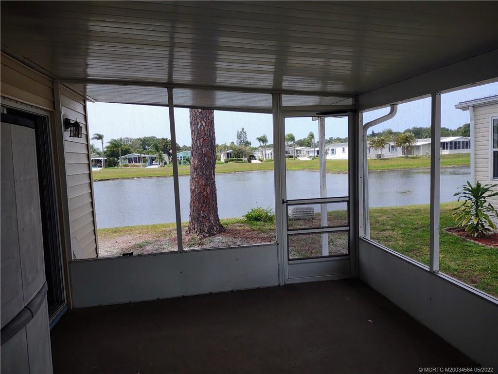 524 Thames Bluff Ridge, Unit D18 Fort Pierce, FL 34982 - Photo 24 of 24 a view of a glass door with a balcony from a living room