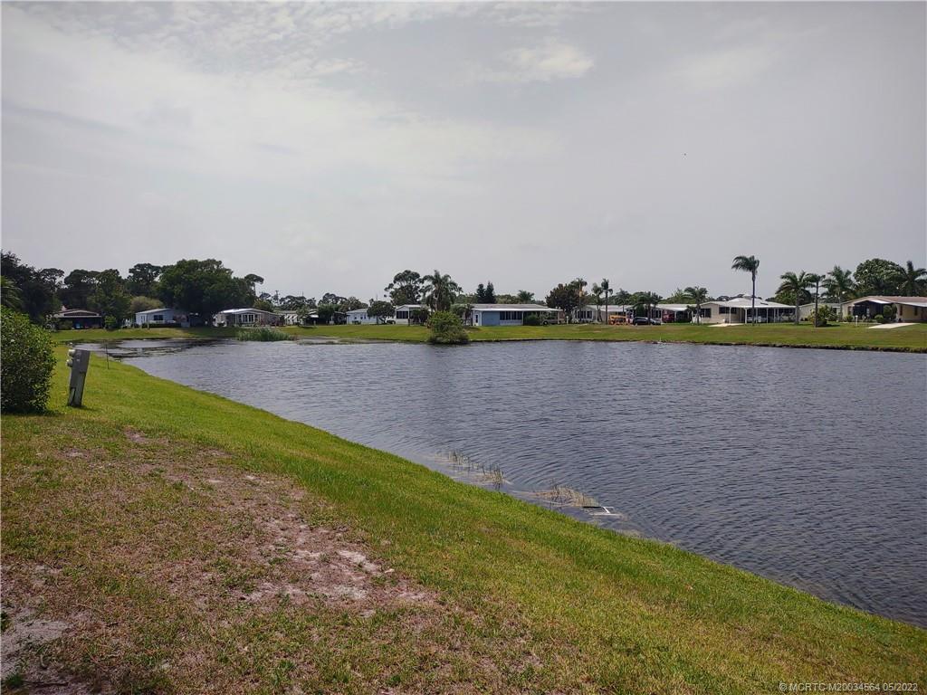 524 Thames Bluff Ridge, Unit D18 Fort Pierce, FL 34982 - Photo 5 of 24 a view of a lake with houses in the back