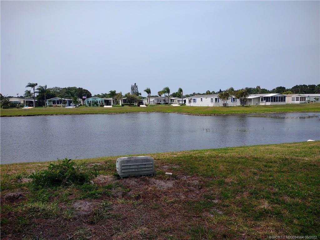 524 Thames Bluff Ridge, Unit D18 Fort Pierce, FL 34982 - Photo 6 of 24 a view of a lake with houses in the back