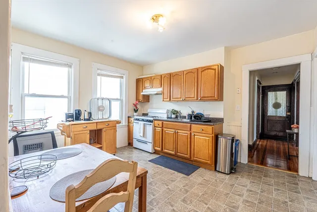 a large kitchen with granite countertop lots of counter top space and stainless steel appliances