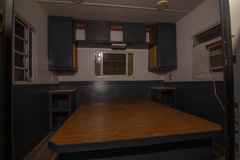 71 6th Street Ellijay, GA 30540 - Photo 2 of 9 a room with kitchen island stainless steel appliances and wooden cabinets