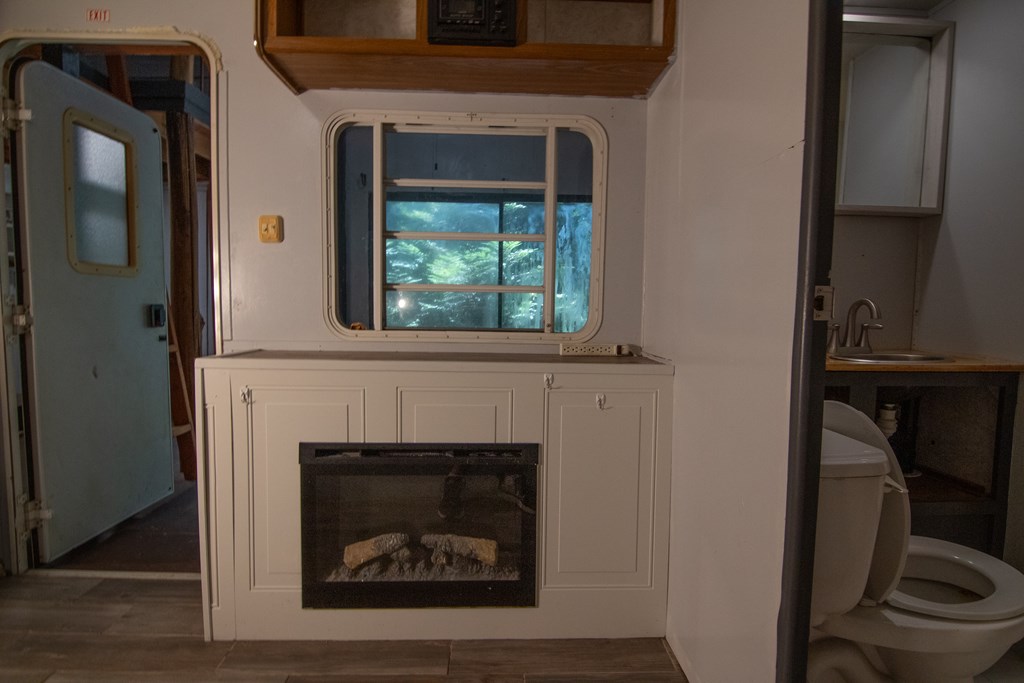 71 6th Street Ellijay, GA 30540 - Photo 4 of 9 a living room with a fireplace and a window