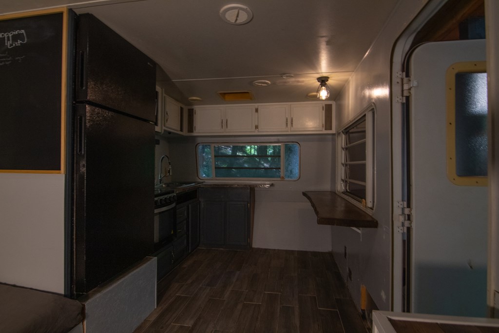 71 6th Street Ellijay, GA 30540 - Photo 7 of 9 a kitchen with stainless steel appliances a refrigerator and a stove