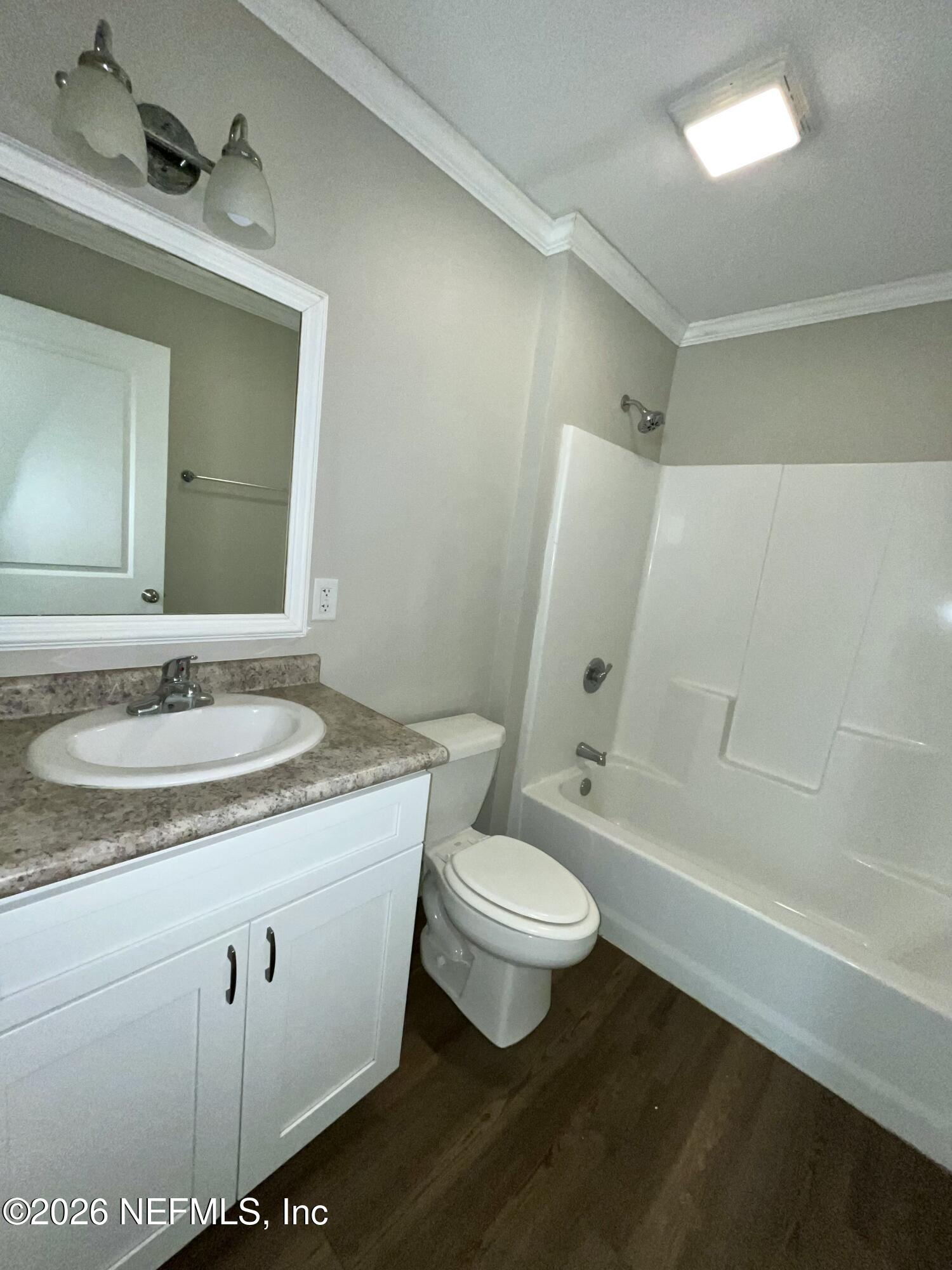 2017 Talladega Road Jacksonville, FL 32209 - Photo 32 of 34 a bathroom with a granite countertop sink toilet a mirror and bathtub