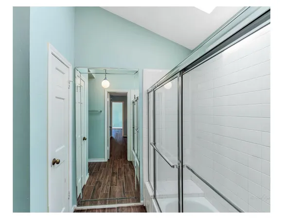 a view of hallway with wooden floor