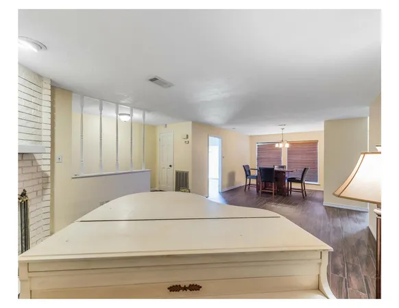 a spacious bedroom with a bed a table and chair