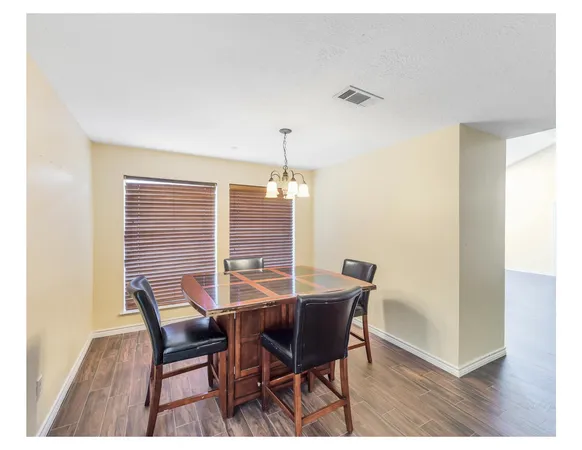 a view of a dining room with furniture and window