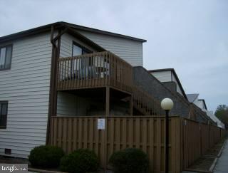 0 Edward Taylor Road, Unit 129 Ocean City, MD 21842 - Photo 1 of 6 a view of a house with wooden fence