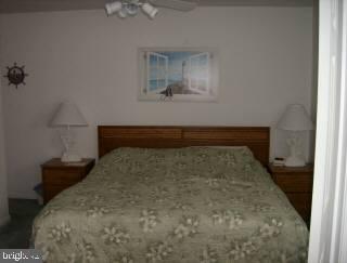 0 Edward Taylor Road, Unit 129 Ocean City, MD 21842 - Photo 5 of 6 a bed sitting in a bedroom next to a window