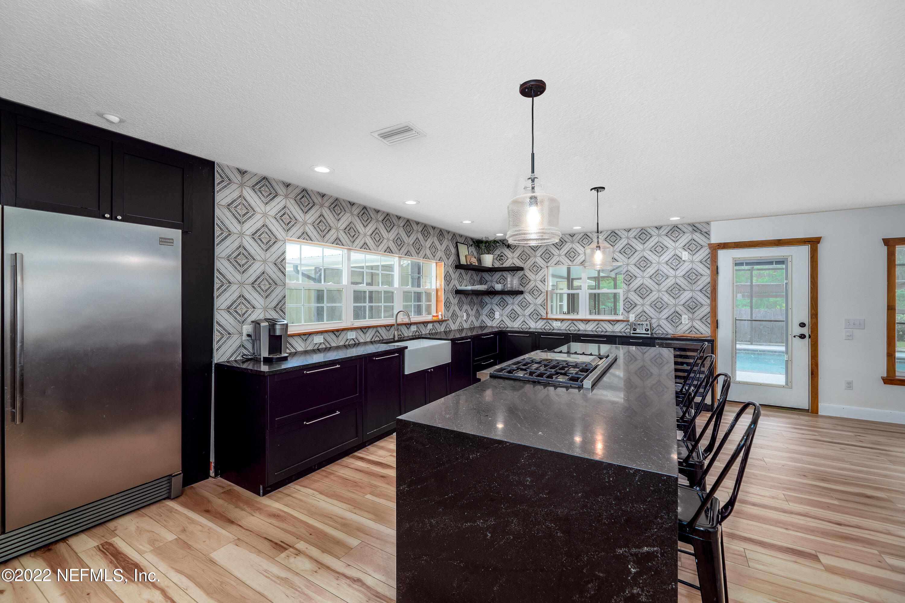 541 Federal Point Road East Palatka, FL 32131 - Photo 17 of 75 a kitchen with a table chairs refrigerator and window