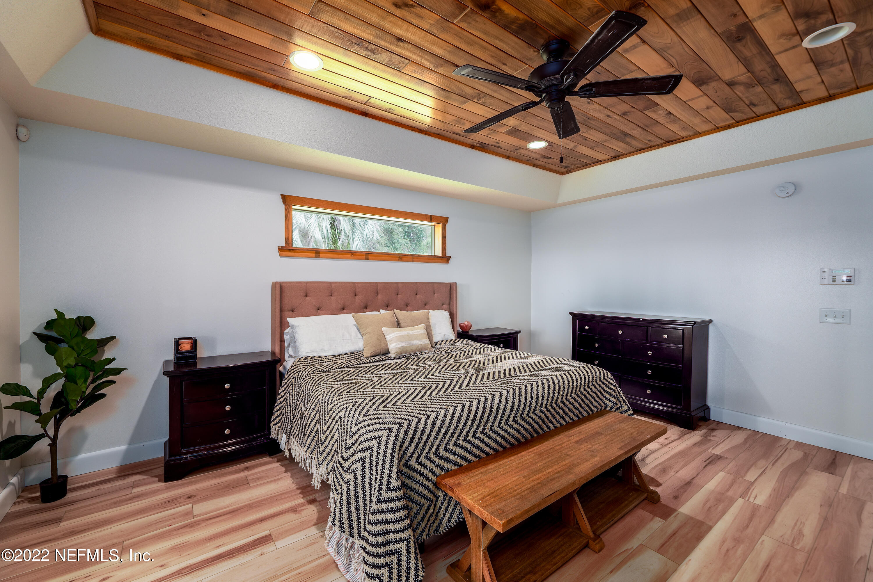 541 Federal Point Road East Palatka, FL 32131 - Photo 23 of 75 a bedroom with a bed and a chandelier
