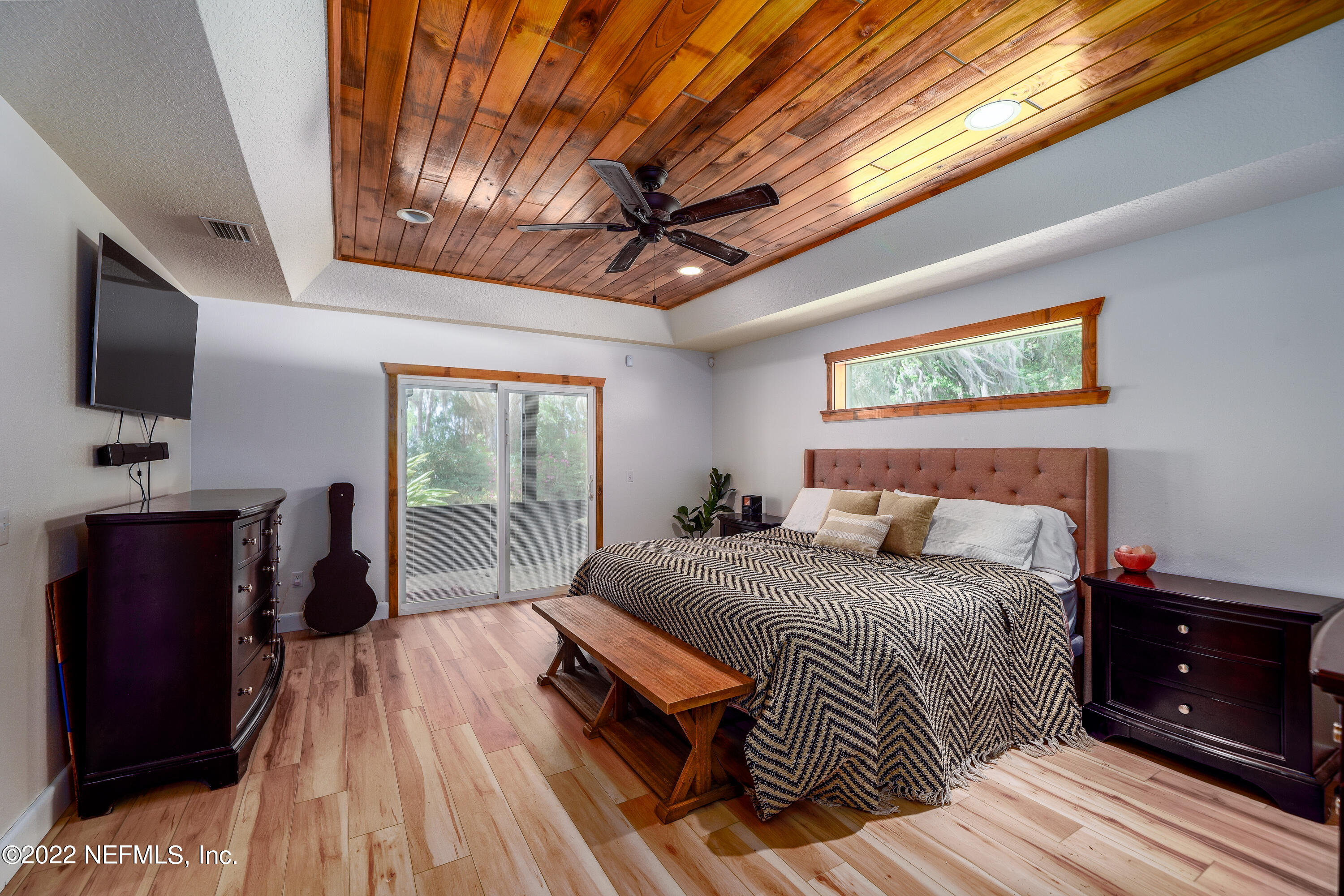 541 Federal Point Road East Palatka, FL 32131 - Photo 24 of 75 a bedroom with a bed and a flat tv screen on dresser