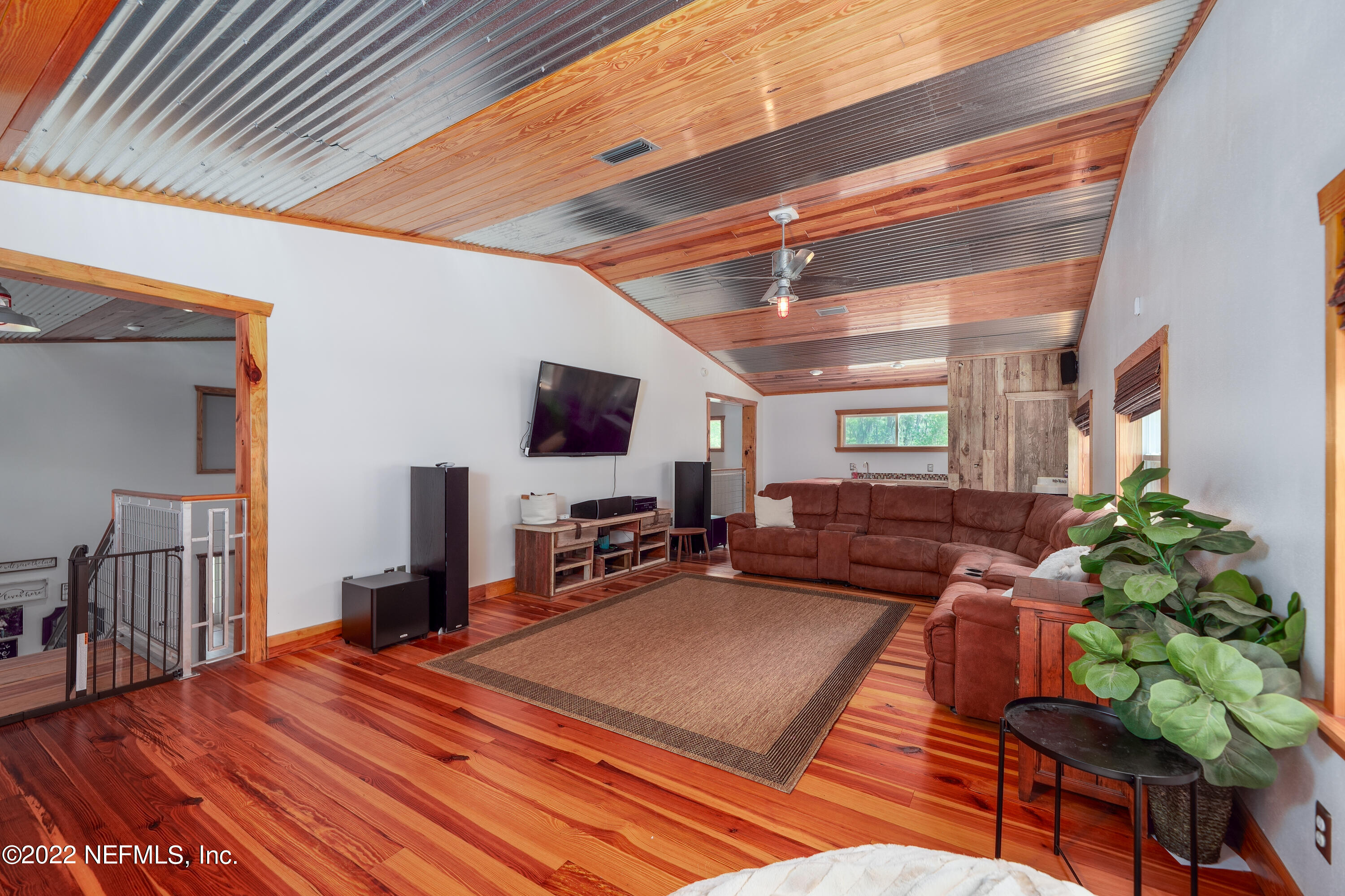 541 Federal Point Road East Palatka, FL 32131 - Photo 32 of 75 a bedroom with furniture and a flat screen tv