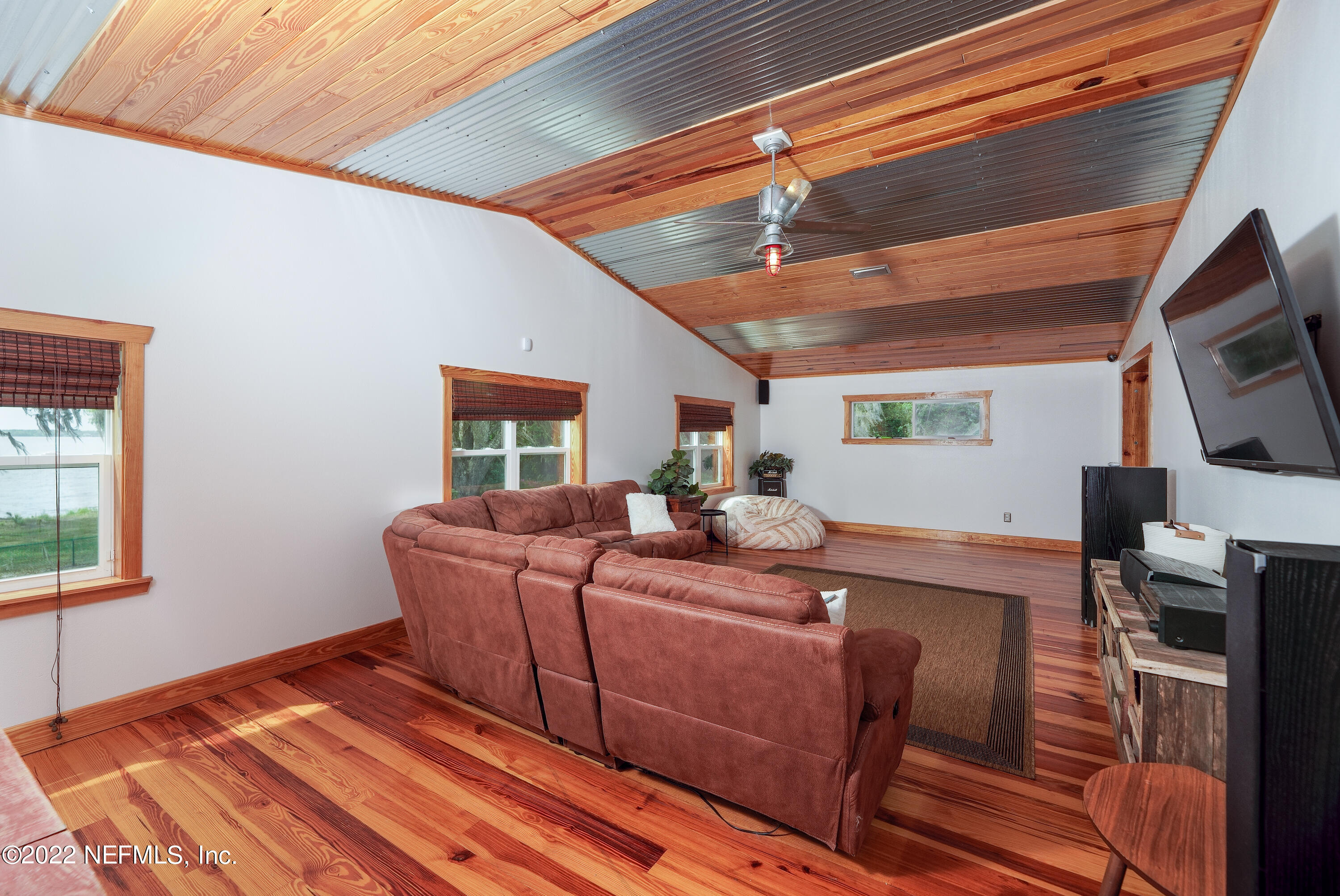 541 Federal Point Road East Palatka, FL 32131 - Photo 34 of 75 a living room with furniture a flat screen tv and a fireplace